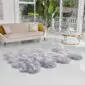 00002_Still-square Large steel grey octo sheepskin rug with a thick, fluffy texture on a white floor.