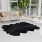 Large octo black sheepskin rug with a thick, fluffy texture and natural scalloped edges.