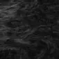 Close-up of thick, long-pile black sheepskin wool texture.