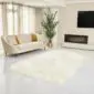 Large ivory white Icelandic sheepskin rug with long wool fibres and natural scalloped edges.