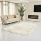 23_British White Large natural white sheepskin rug with a thick, textured wool pile and irregular organic edges.