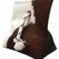 Pyramid shaped brown and white cowhide door stopper with a rope handle and metal eyelet.
