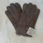 A pair of dark ash suede sheepskin kids' gloves with visible stitching and a small white tag.