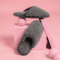 Pair of grey textured wool slippers with a slip-on design and rounded toes.