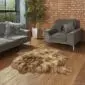 A rusty brown, long-haired Icelandic double sheepskin rug on a wooden floor.