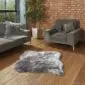Hide Rugs_Lifestyle_0019 A grey and white shorn Icelandic sheepskin rug with a natural double-skin shape on a wooden floor.
