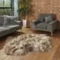 Large taupe Icelandic sheepskin rug with long, thick wool pile on a wooden floor.