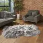 Large grey and white Icelandic sheepskin rug with long, shaggy wool on a wooden floor.