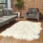 Hide Rugs_Lifestyle_0088 Large ivory Icelandic sheepskin rug with long, thick wool and natural curved edges on a wooden floor.