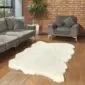 Large cream shorn Icelandic sheepskin rug with natural scalloped edges on a wooden floor.