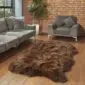 Large four-skin rare breed sheepskin rug with thick, textured brown and tan wool on a wooden floor.