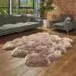 Large, thick-pile Sexto Paco sheepskin rug in a natural taupe colour with an irregular organic shape.