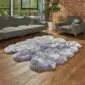 Hide Rugs_Lifestyle_0316 Large steel grey sexto sheepskin rug with a thick, fluffy texture and natural scalloped edges on a wooden floor.