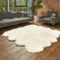 Large ivory octo sheepskin rug with a thick, fluffy texture and natural scalloped edges on a wooden floor.