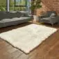 Rectangular cream British sheepskin rug with straight edges on a wooden floor.