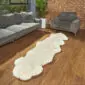 Hide Rugs_Lifestyle_0514 Long, ivory white double sheepskin rug with a natural wavy edge on a wooden floor.