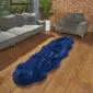 Long navy blue double sheepskin rug with a thick, textured pile on a wooden floor.