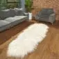 Long ivory Icelandic sheepskin rug with thick, shaggy wool on a wooden floor.