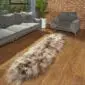 Hide Rugs_Lifestyle_0550 Long, double taupe Icelandic sheepskin rug with thick, shaggy wool on a wooden floor.