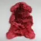 IMG_0055 Natural shaped merlot red sheepskin rug with thick, textured wool pile.
