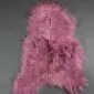 IMG_0897 Long-haired dusty rose Icelandic sheepskin rug with a natural organic shape and thick, shaggy texture.