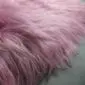 IMG_0907 Close-up of a dusty rose Icelandic sheepskin rug showing long, soft, pink-toned wool fibres.