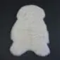 Ivory shorn Icelandic sheepskin rug with a natural pelt shape and short, dense wool pile.