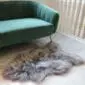 Long-haired grey Icelandic sheepskin rug with natural irregular edges on a light floor.