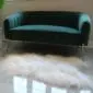 Long-haired ivory Icelandic sheepskin rug with natural organic edges placed on a grey floor.