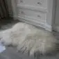 Long-haired ivory Icelandic sheepskin rug with a natural, irregular shape and thick wool texture.
