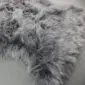 Close-up of a grey sexto sheepskin rug with long, thick, textured wool pile.