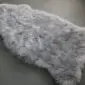 Steel grey sheepskin rug with a thick, textured wool pile and natural organic shape.
