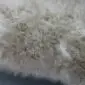 IMG_3390 Close-up of a stone grey sheepskin rug with long, thick wool fibres.