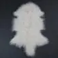 Ivory Mongolian lambskin rug with long, curly wool and a natural pelt shape .