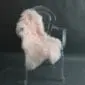 Long-haired blush pink Mongolian lambskin rug laid flat.