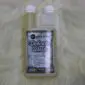 A twin-neck plastic bottle of Merino Wool and Delicates Wash with white screw caps and a printed label.