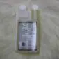 A twin-neck plastic bottle of Merino Wool and Delicates Wash with a white label and two white screw caps.