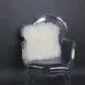 Square ivory sheepskin cushion with long, thick wool texture on a .