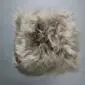 Square taupe Icelandic sheepskin pad with long, shaggy wool fleece.