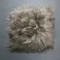 Square taupe Icelandic sheepskin pad with long, thick wool fibres.
