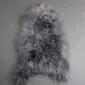 Long-haired Icelandic sheepskin rug in mottled grey and white tones with a natural organic shape.