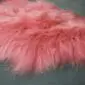 Long-haired Icelandic sheepskin rug in light coral pink.