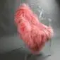 Long-haired Icelandic sheepskin rug in light coral pink laid flat.