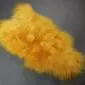 Golden yellow Icelandic sheepskin rug with long, thick wool and a natural hide shape.