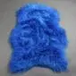 Cobalt blue Icelandic sheepskin rug with long, shaggy wool and a natural hide shape.