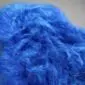 Close-up of a cobalt blue Icelandic sheepskin rug with long, thick, textured wool.