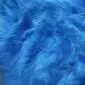 Close-up of cobalt blue Icelandic sheepskin rug showing long, textured wool fibres.