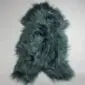 Long-haired Icelandic sheepskin rug in bottle green with a natural pelt shape.