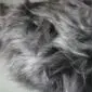 IMG_8548 Close up of a graphite grey Icelandic sheepskin rug with long, wavy natural wool fibres.