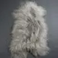 Long-haired Icelandic sheepskin rug in a linen grey colour with a natural hide shape.